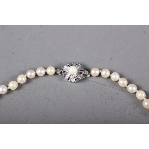 406 - A pearl single-strand necklace, clasp stamped 18k