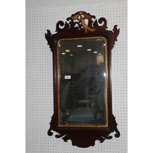 604 - A carved mahogany framed wall mirror with gilt Hoho bird crest, 36