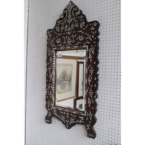 605 - A Moresque hardwood and mother-of-pearl white metal inlaid shape framed wall mirror with rectangular... 