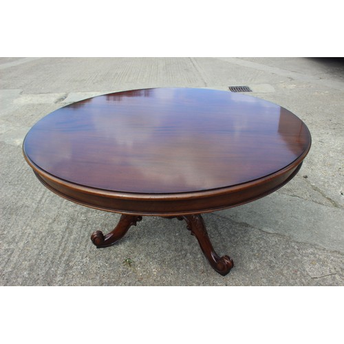 538 - A well-reproduced mahogany circular dining table, on triform carved scroll base, 54