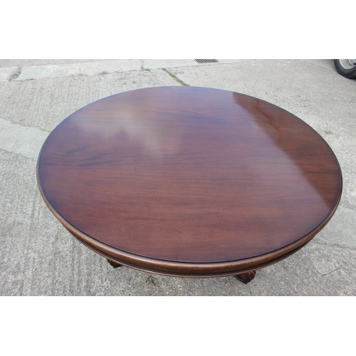 538 - A well-reproduced mahogany circular dining table, on triform carved scroll base, 54