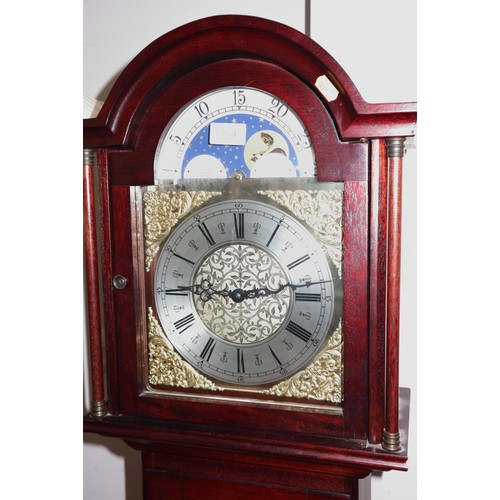 600 - A modern mahogany long case clock with brass arch top dial and eight-day striking and chiming moveme... 