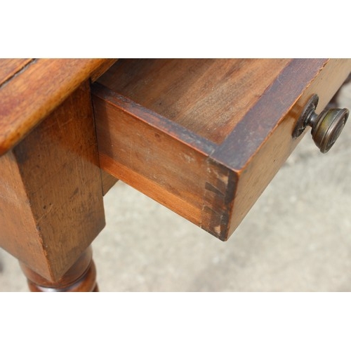 601 - A mahogany side table, fitted two drawers with brass handles, on turned supports, 35