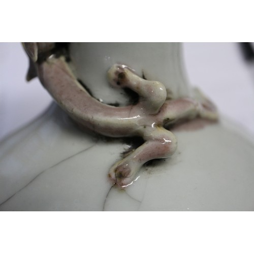 102 - A Chinese pale glazed bottle with relief lizard decoration, 7 1/2