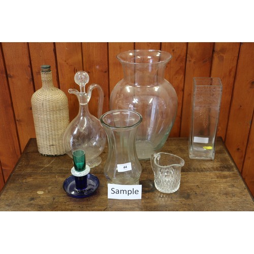 44 - A quantity of mostly clear glass vases, jugs and bowls, including a jug and stopper with etched deco... 