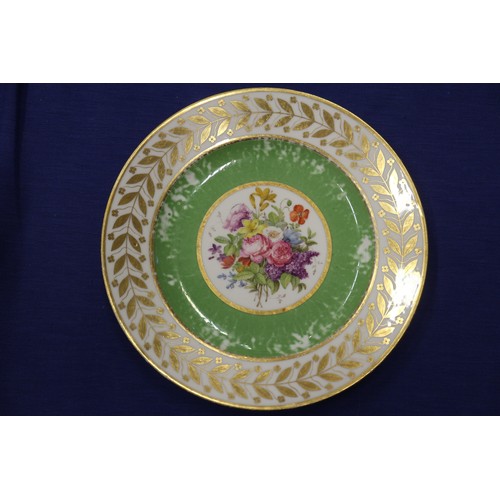 56 - Fourteen Sevres dessert plates with central floral decoration and green and gilt borders, 9 1/4