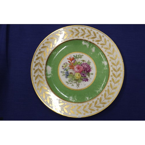 56 - Fourteen Sevres dessert plates with central floral decoration and green and gilt borders, 9 1/4