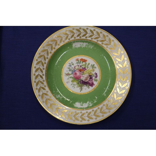 56 - Fourteen Sevres dessert plates with central floral decoration and green and gilt borders, 9 1/4