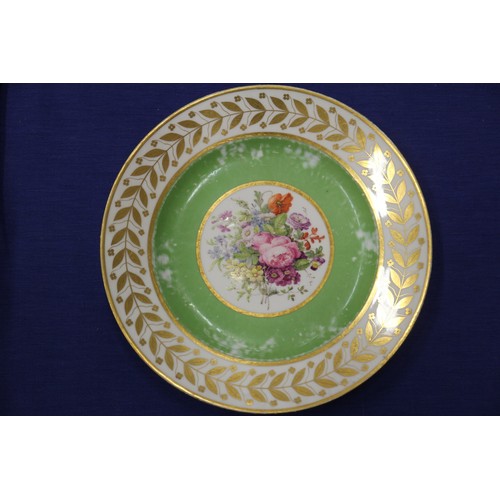 56 - Fourteen Sevres dessert plates with central floral decoration and green and gilt borders, 9 1/4