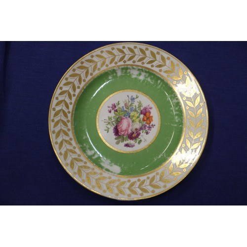 56 - Fourteen Sevres dessert plates with central floral decoration and green and gilt borders, 9 1/4