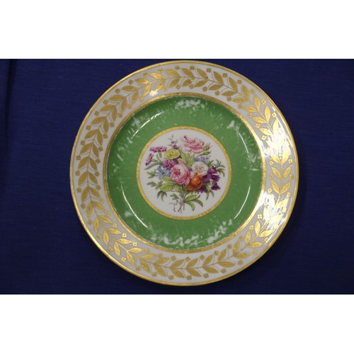 56 - Fourteen Sevres dessert plates with central floral decoration and green and gilt borders, 9 1/4