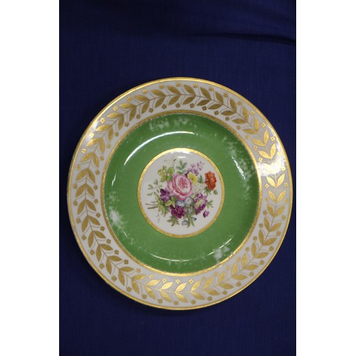 56 - Fourteen Sevres dessert plates with central floral decoration and green and gilt borders, 9 1/4