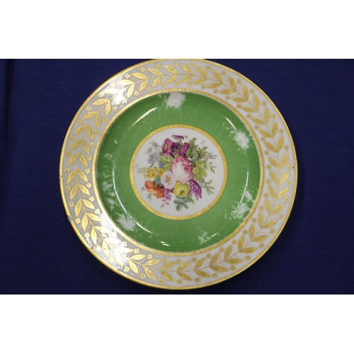 56 - Fourteen Sevres dessert plates with central floral decoration and green and gilt borders, 9 1/4