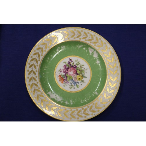 56 - Fourteen Sevres dessert plates with central floral decoration and green and gilt borders, 9 1/4