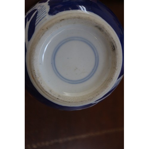 120 - Three Chinese blue and white ginger jars and covers with prunus decoration and double ring marks to ... 