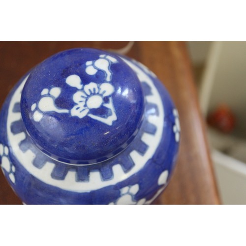 120 - Three Chinese blue and white ginger jars and covers with prunus decoration and double ring marks to ... 