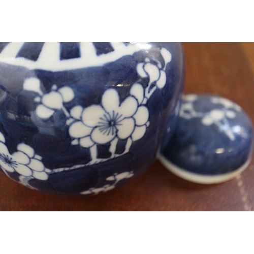 120 - Three Chinese blue and white ginger jars and covers with prunus decoration and double ring marks to ... 