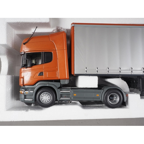 136 - A Minichamps die-cast model Scania Tautliner/Curtainsider (nearside wing mirror damaged), in associa... 