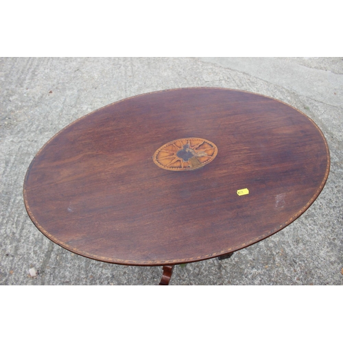 521 - A late 19th century walnut and inlaid oval top occasional table, on turned column and tripod scroll ... 