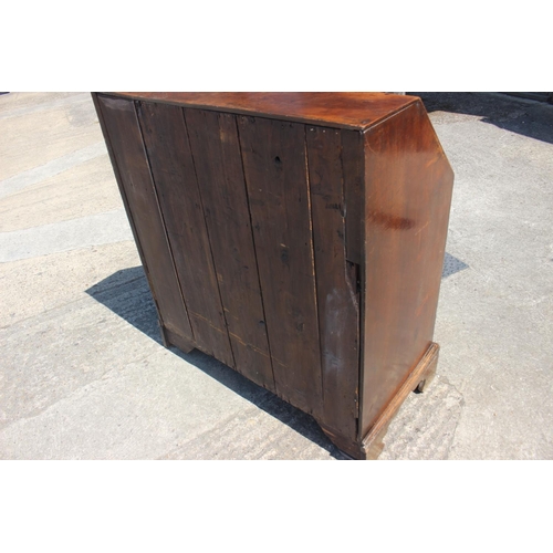 527 - A Georgian mahogany bureau with fitted interior over four long graduated drawers, on bracket support... 