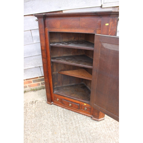 549 - A late Georgian quarter cut oak and mahogany banded corner hanging cupboard enclosed glazed panel do... 