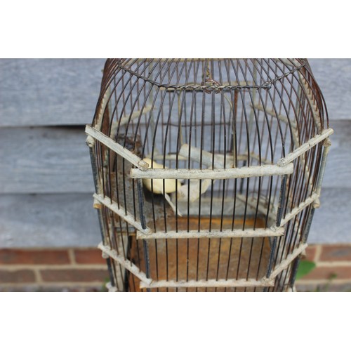 158 - A wirework octagonal domed birdcage, on square base, 20 3/4