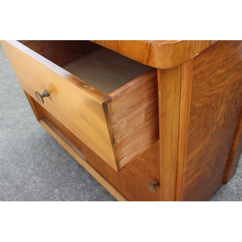 598 - A 1950s figured walnut sideboard with glazed doors over shelves, three drawers and cupboards enclose... 