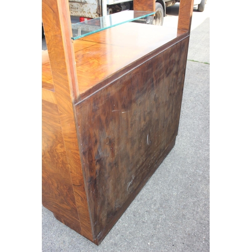 598 - A 1950s figured walnut sideboard with glazed doors over shelves, three drawers and cupboards enclose... 