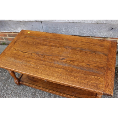 610 - An oak low two-tier coffee table, fitted one drawer, on turned supports, 40