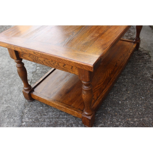 610 - An oak low two-tier coffee table, fitted one drawer, on turned supports, 40