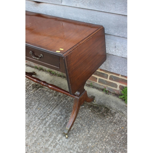 612 - A mahogany and banded sofa table, fitted two drawers, on shaped supports, 36