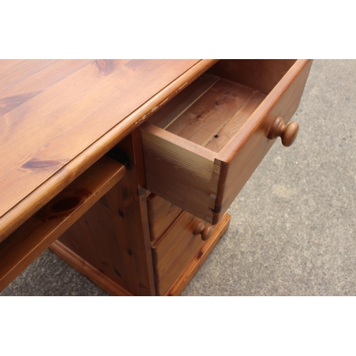 617 - A pine double pedestal desk, fitted cupboard and three drawers, 54