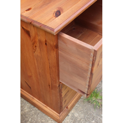 617 - A pine double pedestal desk, fitted cupboard and three drawers, 54