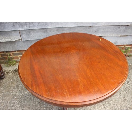 619 - A mahogany circular tilt top dining table, on turned column and tripod splay supports, 39