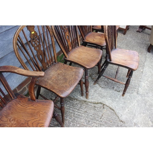 609 - A set of six late 19th century Windsor wheelback chairs with elm panel seats, on turned and stretche... 