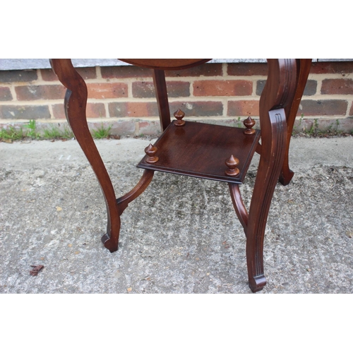 658 - An Edwardian walnut quadruple drop leaf occasional two-tier table, on shaped supports, 18