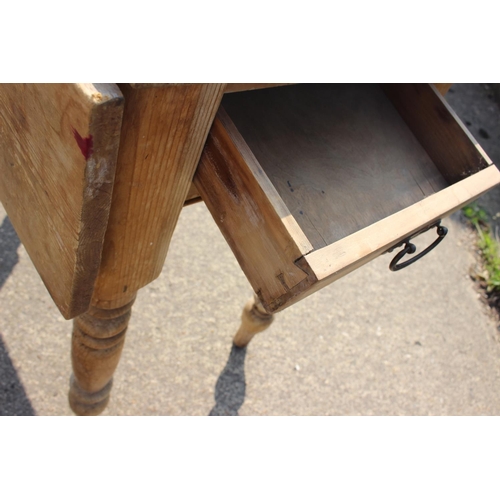 683 - A waxed pine single drop leaf table with scrubbed top, 36