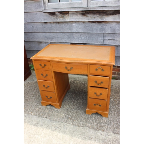 684 - A waxed pine double pedestal desk with tooled leather lined top, fitted nine drawers, 37