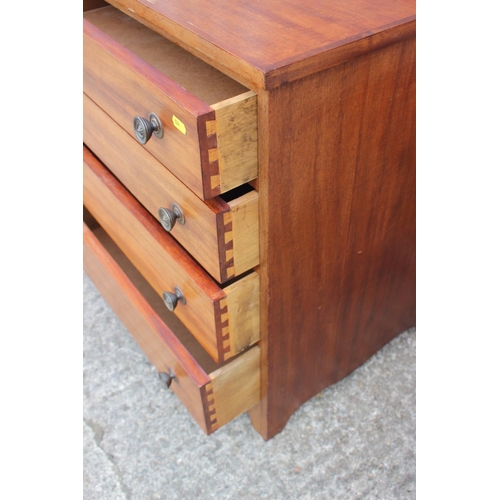 699 - A pine chest of four long drawers with brass knob handles, 25