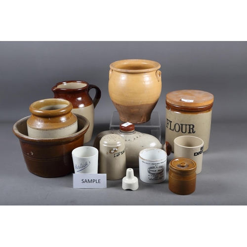 22 - A selection of stoneware items, including two feet warmers, a flour jar, two plant pots, a 