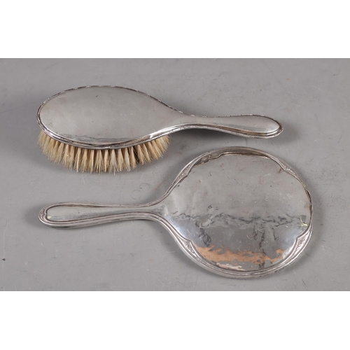 356 - A silver backed dressing table mirror and a similar brush