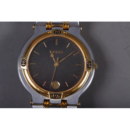 409 - A gentleman's stainless steel and gilt metal bracelet watch with black dial, baton numerals and date... 