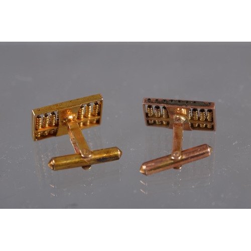 411 - A pair of yellow metal cufflinks, formed as abacuses, stamped '14K' 6.8g