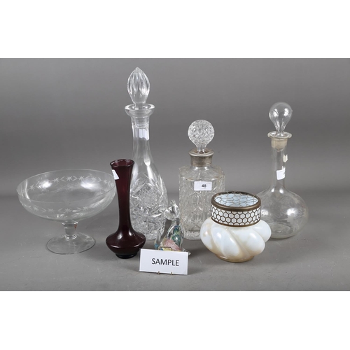 48 - An assortment of glassware, including four decanters and stoppers, an art glass paperweight, formed ... 