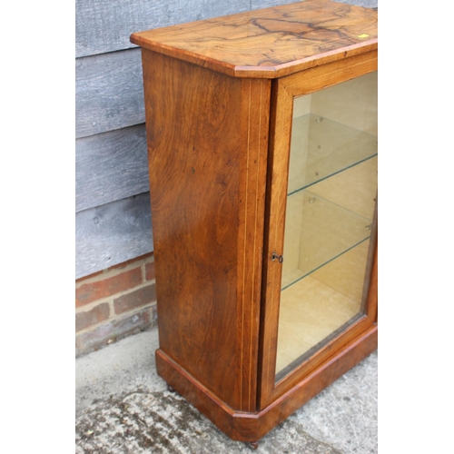 525 - A 19th century walnut an line inlaid side cabinet with two glazed shelves enclosed glazed door, on b... 