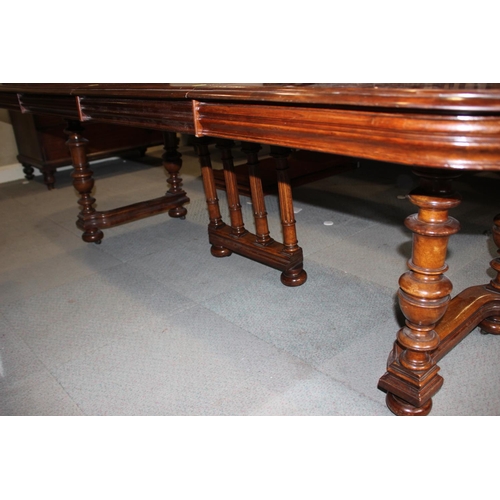 529 - A late Victorian mahogany extending dining table with two extra leaves, on four corner supports and ... 