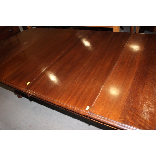 529 - A late Victorian mahogany extending dining table with two extra leaves, on four corner supports and ... 