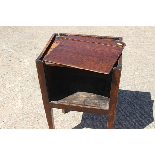 536 - An early 19th century provincial oak tray top bedside cupboard with lift up front, on square taper s... 