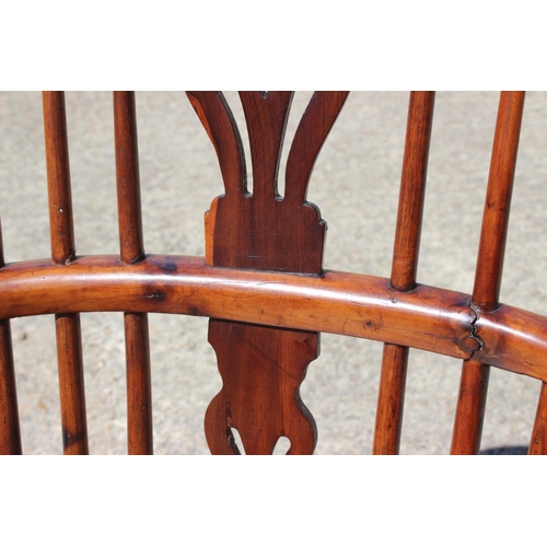 537 - A 19th century yew splat bow back elbow chair with elm panel seat, on fruitwood turned and stretcher... 