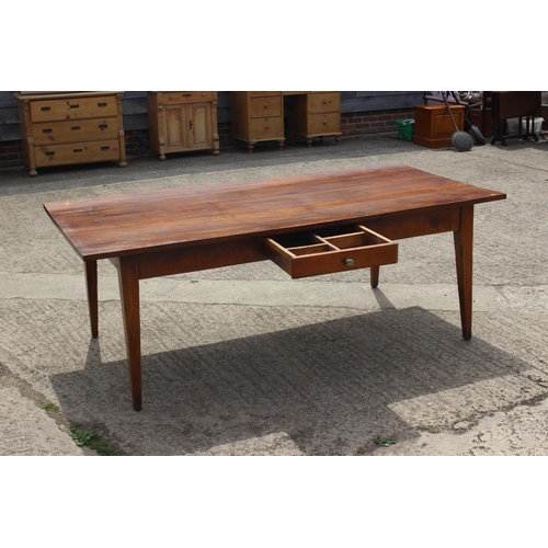 541 - A 19th century French cherrywood farmhouse dining table, fitted one frieze drawer, on square taper s... 